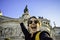 Piazza Venezia, Roma, Italy. Happy smiling young woman taking selfie with the front of the monument to Victor Emmanuel II in the b