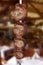 Picanha with garlic, bovine rump meat, traditional brazilian barbecue whole piece on skewer isolated blur background