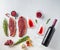 Picanha steak with bottle of red wine and glass,  herbs and pomegranate top view over white textured background . Big size