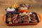 Picanha, a traditional cut of Brazilian meat, served with grilled onion and sausage on a hot iron plate. Brazilian barbecue served