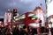 Piccadilly Circus, London - - February 14th of 2015: Lots of people. cars and typical red buses crossing the streets in this