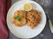 Piccata Milanese. Veal fillet in parmesan coating fried in butter with spaghetti pomodoro. Spaghetti in tomato sauce and herbs.