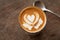 Piccolo Latte art in small glass on wooden table