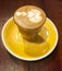 Piccolo latte coffee on yellow plate