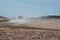 Pick up truck driving in the dry desert road and making dust.