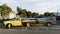 A pick up truck and trailer parked across three push chair and baby parking bays