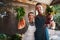 Pick your favorite. Portrait of a happy young couple posing together holding bunches of freshly picked carrots and