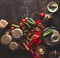 Pickle vegetables preparation on dark rustic background with ingredients,  vinegar bottle , seasoning and jars. Top view. Copy