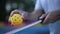 Pickleball player practicing to serve a ball with a racket in slow motion