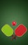 Pickleball two crossed rackets and sports ball Christmas decoration on a green background. 3d rendering