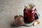 Pickled beets in glass jar on table, space for text