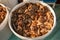 Pickled boletus mushrooms in a plastic bucket at the fair. Altai salted mushrooms - maslyata