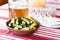 Pickled cucumbers stand on the table behind empty glassware