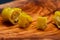 Pickled Golden Greek Peppers, Pepperoncini or Friggitelli sweet Italian chili pepper on natural olive wood cutting board .