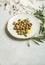 Pickled green Mediterranean olives in olive oil on white plate