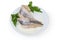 Pickled herring fillets on dish with fresh parsley