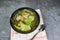 Pickled lettuce soup with spare ribs pork bone soup bowl with vegetable on table