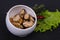 Pickled mussels in the bowl served pepper, garlic and salad