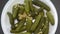 Pickled Seasoned Gherkins or Cucumbers Rotating in White Bowl