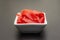 Pickled sushi ginger slices in white bowl on stone background