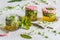 Pickled wild garlic blossoms on white wooden background