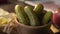 Pickles are in the wooden bowl on the kitchen table in a beam of sunset light, canned vegetables, ingredients for