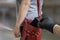 Pickpocket thief is stealing phone from woman from her handbag