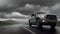 A pickup truck is driving down the road. Dark dramatic landscape as background, gloomy sky with rainy clouds, forest and hill.