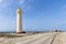 Pickup truck parked next to the historic Willemstoren Lighthouse