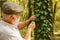 Picky detective in forest. Explore nature. Pensioner with magnifier exploring forest autumn day. Botanist examine plants