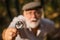 Picky detective in forest. Explore nature. Pensioner with magnifier exploring forest selective focus. Old man scientist