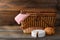 Picnic basket with bread and cheese on wood