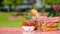 Picnic basket checkered with a tablecloth wine, baguette, strawberry, glasses, banner