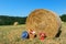 Picnic basket and summer hat in agriculture landscape