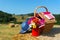 Picnic basket and summer hat in agriculture landscape