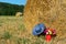 Picnic basket and summer hat in agriculture landscape