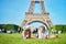 Picnic with basket, wine and fruits near the Eiffel tower in Paris