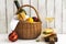 Picnic basket with wine, salmon sandwiches and fruits over white