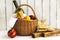 Picnic basket with wine, salmon sandwiches and fruits over white