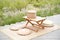 Picnic basket on wooden table. Summertime weekend break concept.