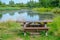 Picnic bench in a rural setting next to a lake