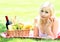 Picnic. Blonde young woman with basket of food