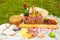 Picnic, camping basket, wine, glasses and fruits, family picnic background with space. Summer and mood. Weekend and vacation,