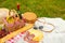 Picnic, camping basket, wine, glasses and fruits, family picnic background with space. Summer and mood. Weekend and vacation,