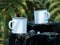 Picnic And Camping Rest Of Travelers: White Blank Enameled Mugs With Copy Space On Rock In Exotic Forest. 3d rendering.