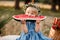 picnic with family. cute little girl eating big piece of watermelon on straw stack in summertime in the park. Adorable