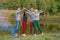 Picnic with friends in at lake near bonfire. Company friends having hike picnic nature background. Hikers relaxing during drink