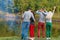 Picnic with friends in at lake near bonfire. Company friends having hike picnic nature background. Hikers relaxing during drink