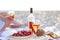 Picnic outdoor with rose wine fruits meat and cheese