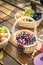 Picnic party wooden table and decoration with fruit baskets: grapes, peaches, plums on a sunny summer day